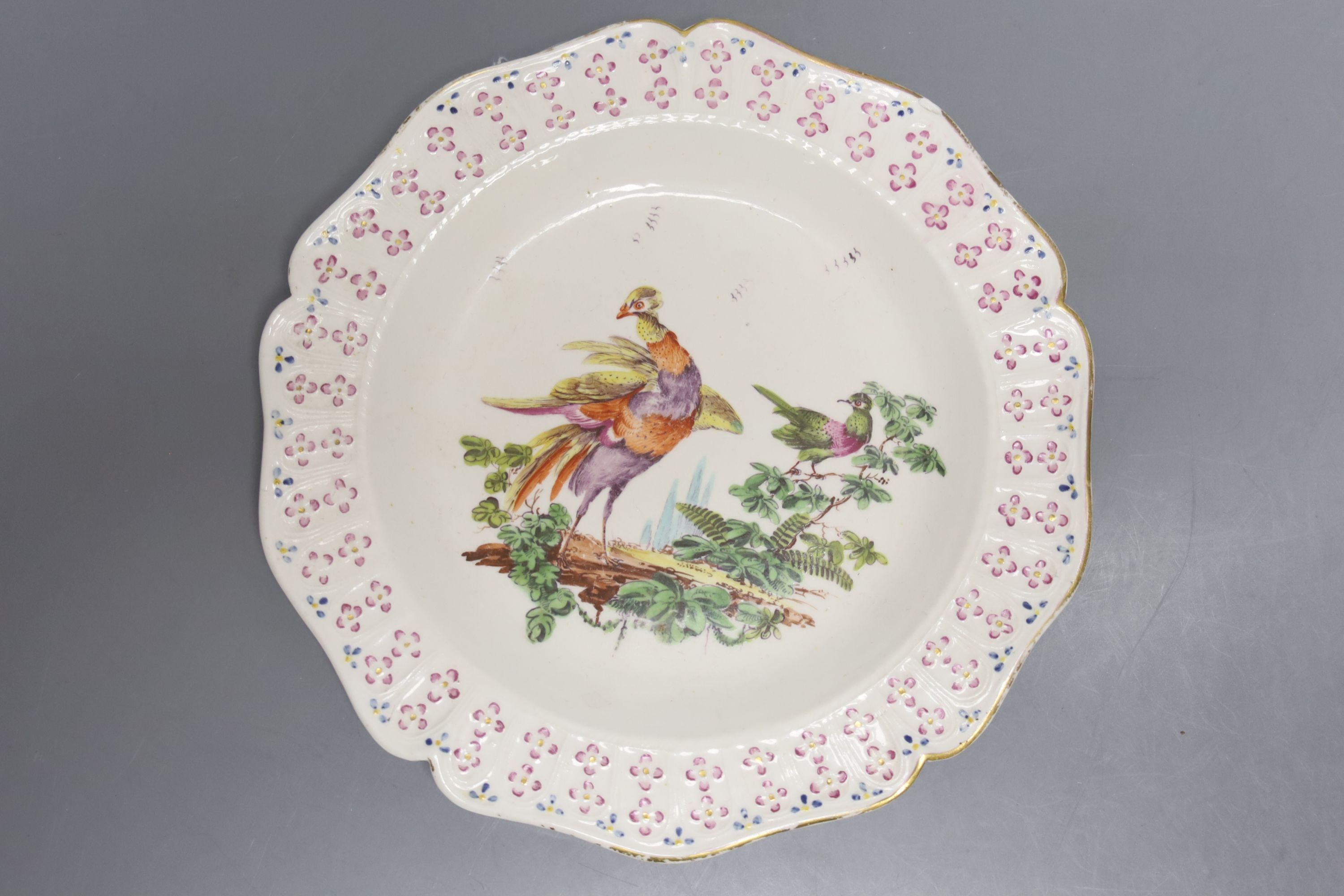 A Derby plate painted with two birds in landscape under a moulded floral border c.1760, Wheeldon Col. label, diameter 21.5cm